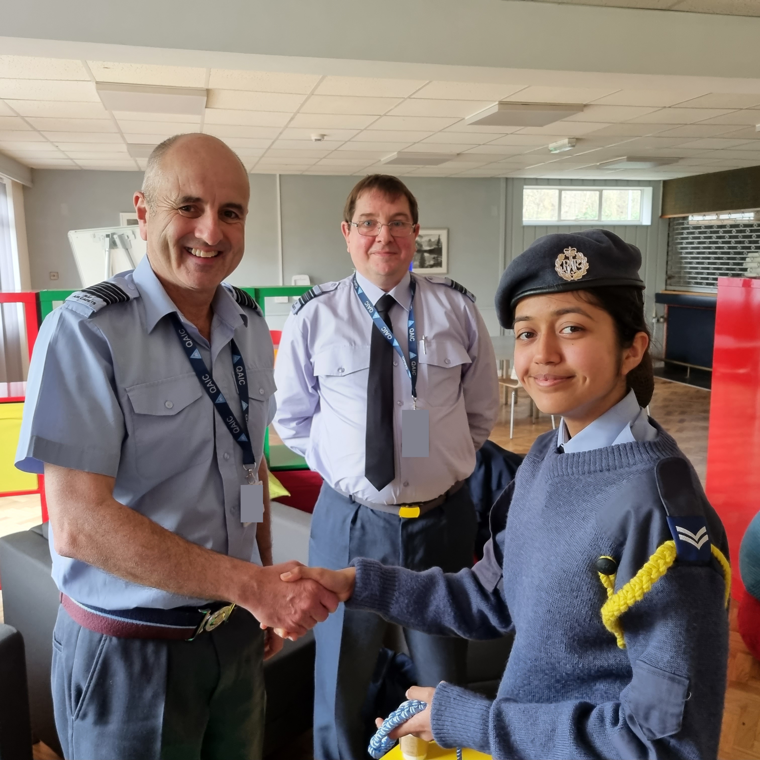 Wing Commander Ian Revell shaking hands with Cpl Simran Kainth